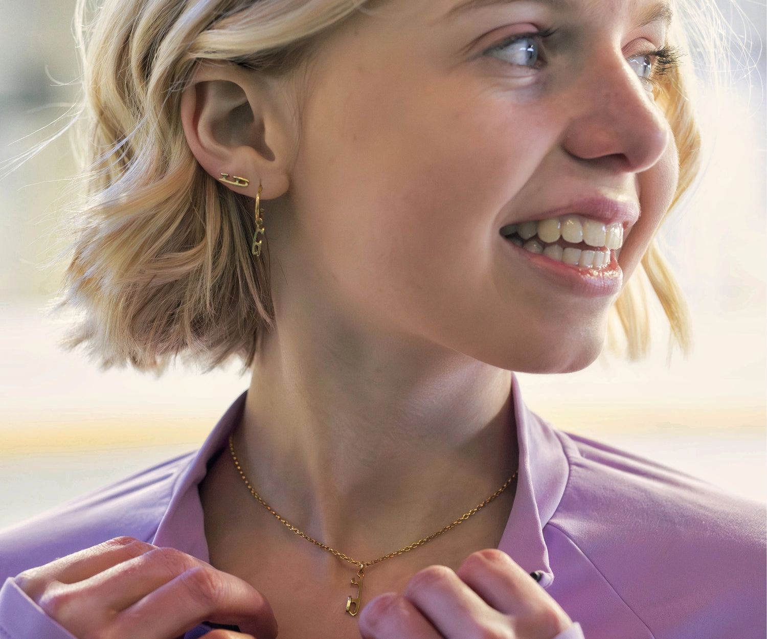 close up of a girl wearing gold ice skate blade earrings
