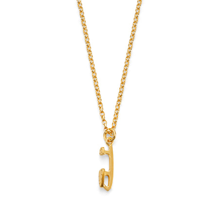 Gold necklace featuring a mini gold ice skating blade charm on a white background