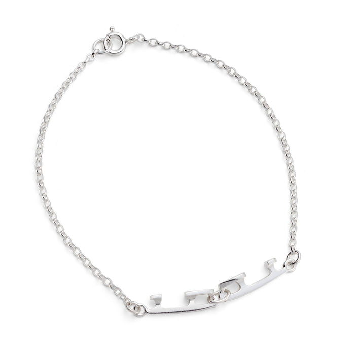 silver bracelet with two tiny interlinked silver ice skating blades