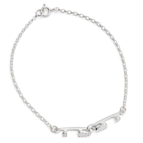 silver bracelet with two tiny interlinked silver ice skating blades