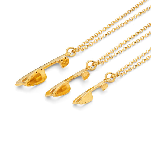 three gold ice skating necklaces which feature tiny gold ice skating blade charms on the chains