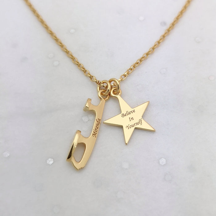 gold ice skate blade and star necklace on a grey sparkly background