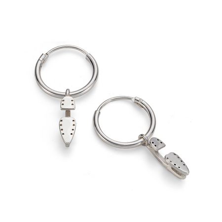 silver hoop earrings with tiny silver ice skate blade charms on a white background