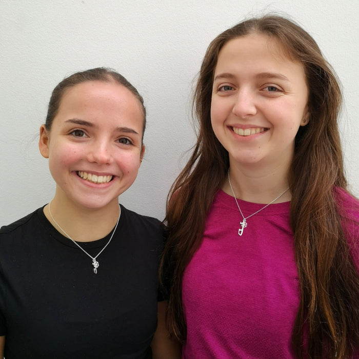 Two figure skaters wearing Snowflake Ice Skating Necklaces | Ice Skating Jewellery
