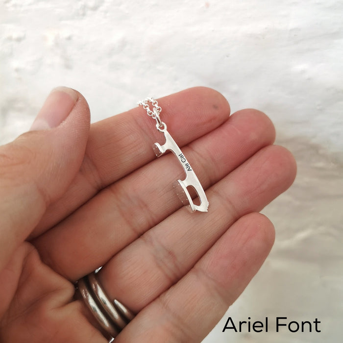 close up of a hand holding an ice skating necklace