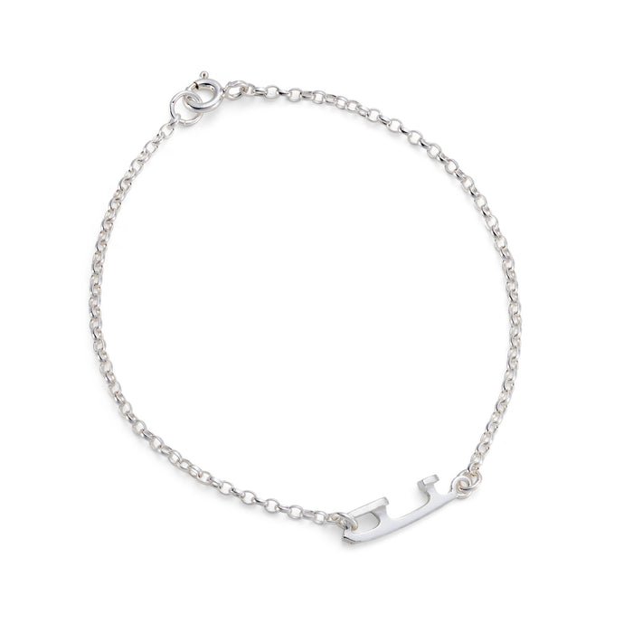 silver ice skating bracelet featuring a tiny ice skate blade on a white background