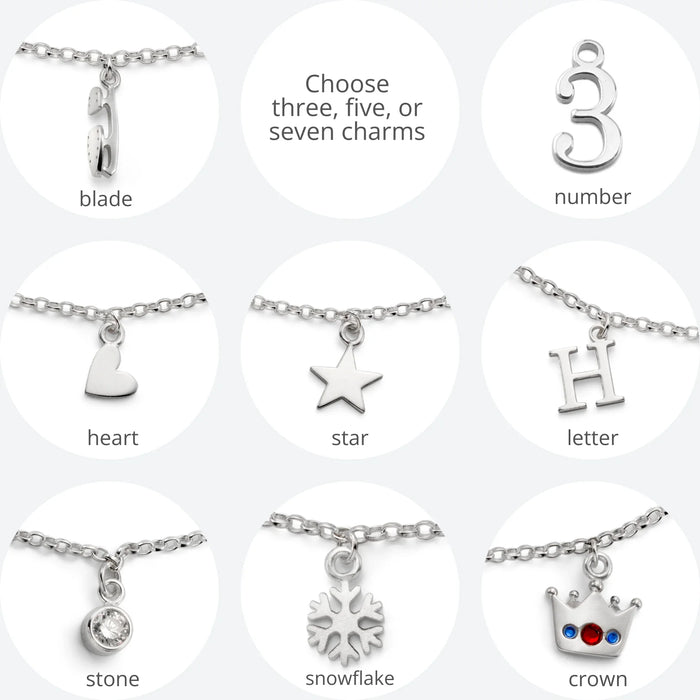 Collection of silver charms on necklaces with options to choose three, five, or seven charms.
