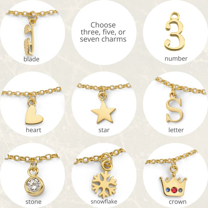 Collection of gold charms on a white background with text indicating options to choose three, five, or seven charms.