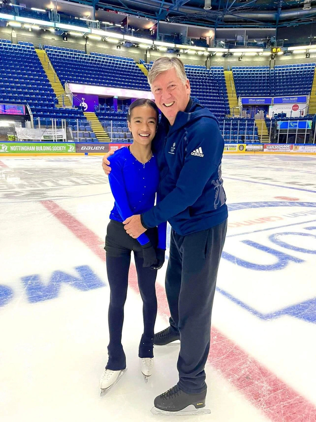 olympic champion figure skater robin cousins and female figure skater both standing on an ice rink