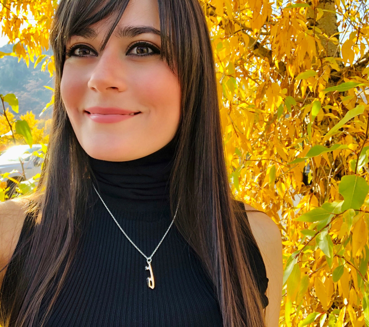 professional figure skater ale izquierdo wearing a personalised silver ice skating necklace in the fall