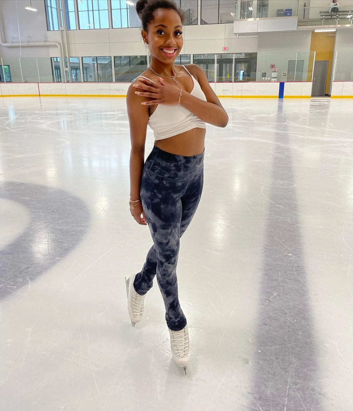 alexa gasparotto standing on an ice rink wearing a bracelt and a necklace made by ice skating jewellery