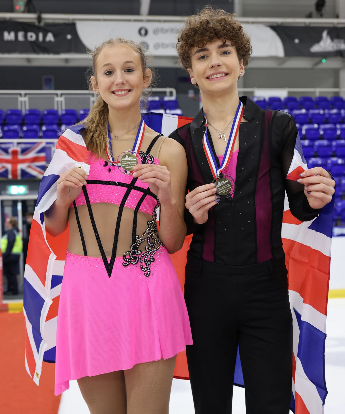 british ice dance couple on the podium holding their silver medals