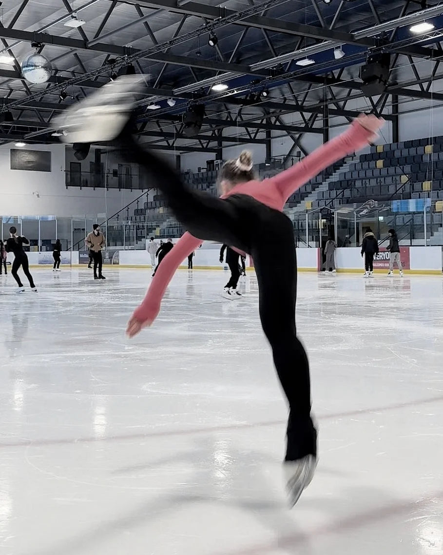 figure skater practising a butterfly on ice in a training session
