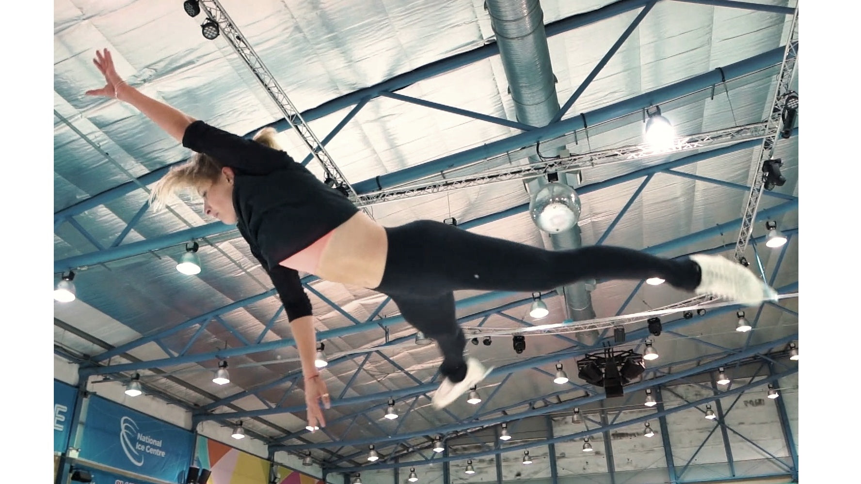 Dynamic below-view snapshot of skater airborne during butterfly move before spin