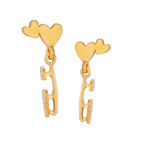 gold ice skate blade and heart stud earrings on a white background