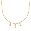 Gold necklace with various charms on a white background