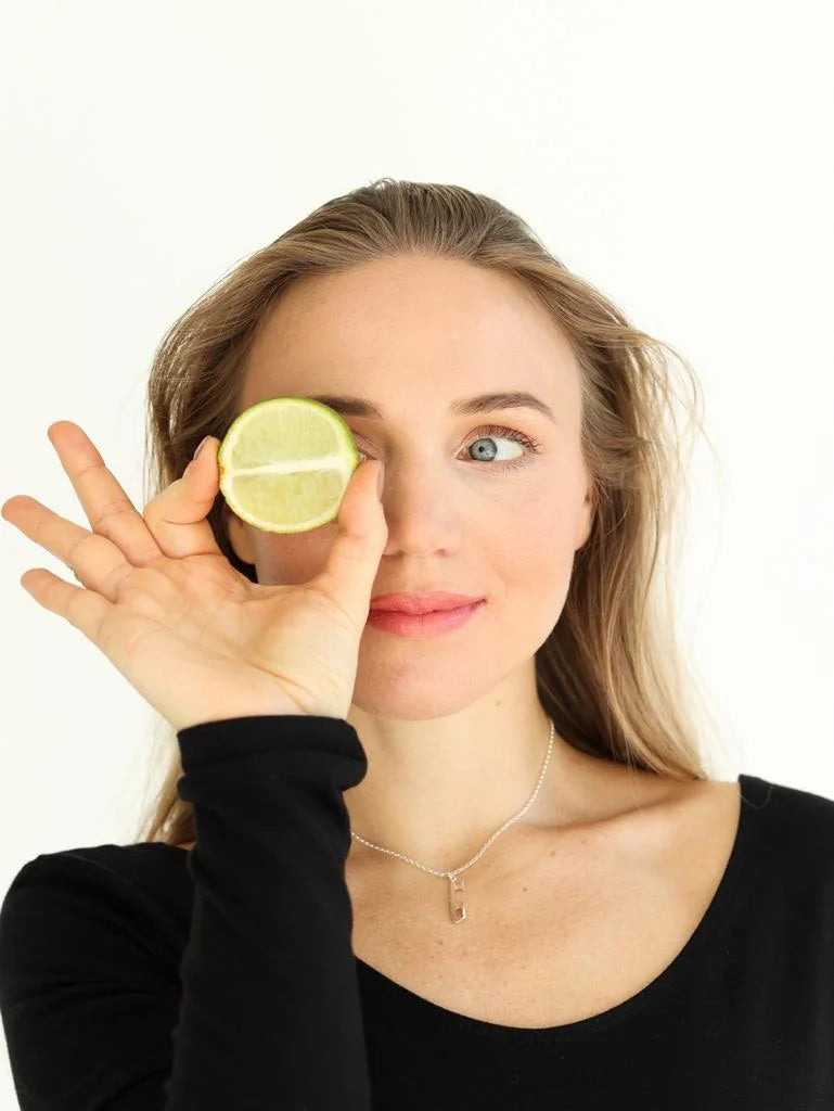 johanna allik holding a lime and wearing a silver ice skating necklace