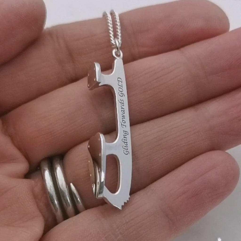 video of a hand holding a personalised ice skate blade charm