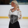 female skater on ice wearing a sparkly dress and silver hoop earrings with tiny ice skate blade charms