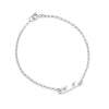 A delicate silver chain bracelet with a small polished silver charm shaped like an ice skate blade, displayed on a clean white background.