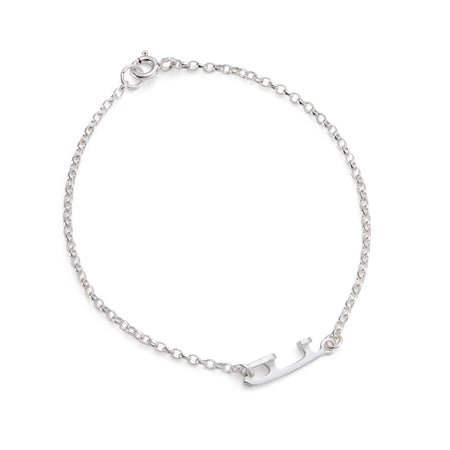 A delicate silver chain bracelet with a small polished silver charm shaped like an ice skate blade, displayed on a clean white background.