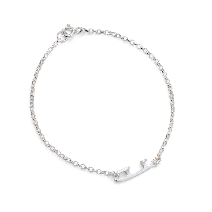 A delicate silver chain bracelet with a small polished silver charm shaped like an ice skate blade, displayed on a clean white background.