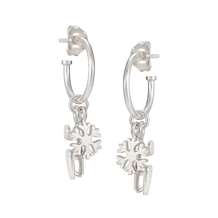 silver stud hoop earrings with snowflake and skating blade charms on a white background