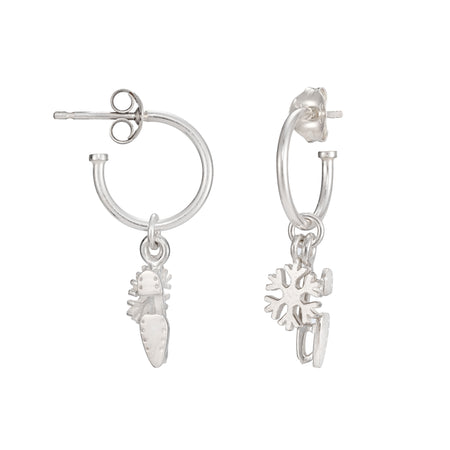 silver stud hoops with ice skate blades and sparkly snowflake charms on a white background