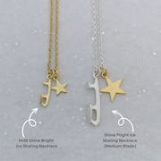 two necklaces featuring silver and gold stars and ice skate blades on a grey background