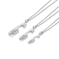 three silver ice skate blade necklaces on a white background